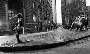 A sculpture of a "fearless girl" staring down Wall Street's charging bull appeared in Lower Manhattan on Wednesday, placed there by the investment firm State Street Global Advisors for International Women's Day. Photo: Federica Valabrega