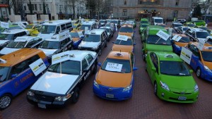 A January 2015 demonstration in Portland, Oregon in favor of applying taxi regulations to ride-sharing apps. Photo by Aaron Parecki, via Wikimedia Commons
