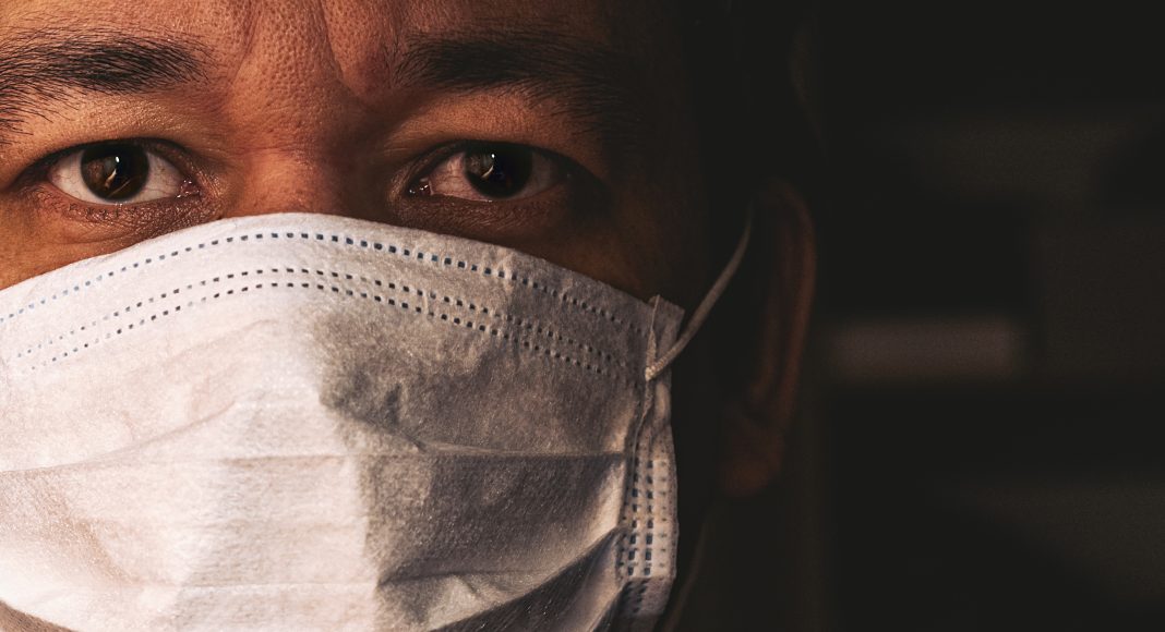 Closeup of man in mask, concept of viral infection. Theme of corona-virus epidemic.