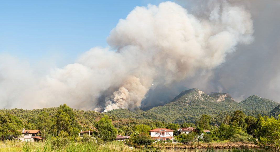 Smoke from a forest fire rising over Hisaronu neighbourhood of Marmaris resort town of Turkey on July 31, 2021.