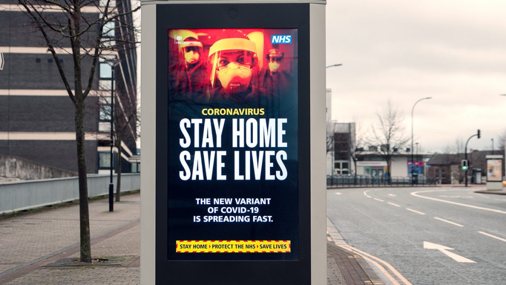 NHS advertisement in Sheffield, United Kingdom warning against a new variant of Covid-19. It reads "Stay Home Save Lives: The New Variant of Covid-19 is Spreading fast"