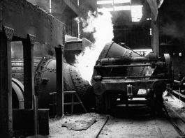 Worker working machinery in a steel foundry